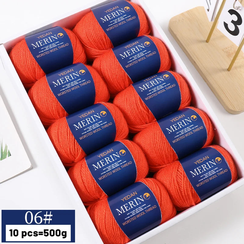 A box of ten skeins of orange merino wool yarn for knitting projects