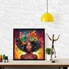 A vibrant painting of an African woman's face with a full floral crown, displayed on a wall above a wooden table.