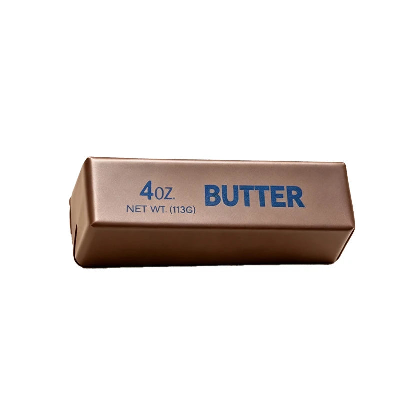 A rectangular brown butter squishy stress relief toy labeled 4oz net wt 113g