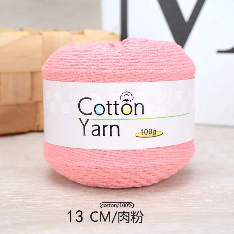 Pink cotton yarn skein labeled as Cotton Yarn 100g with a measurement of 13 cm.