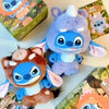 A plush toy of Stitch in blue and purple colors is displayed next to its packaging box.