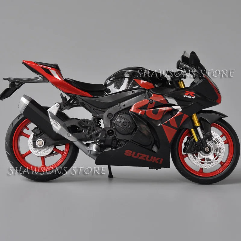 A black and red Suzuki GSX-R1000R diecast motorcycle model in a studio setting.