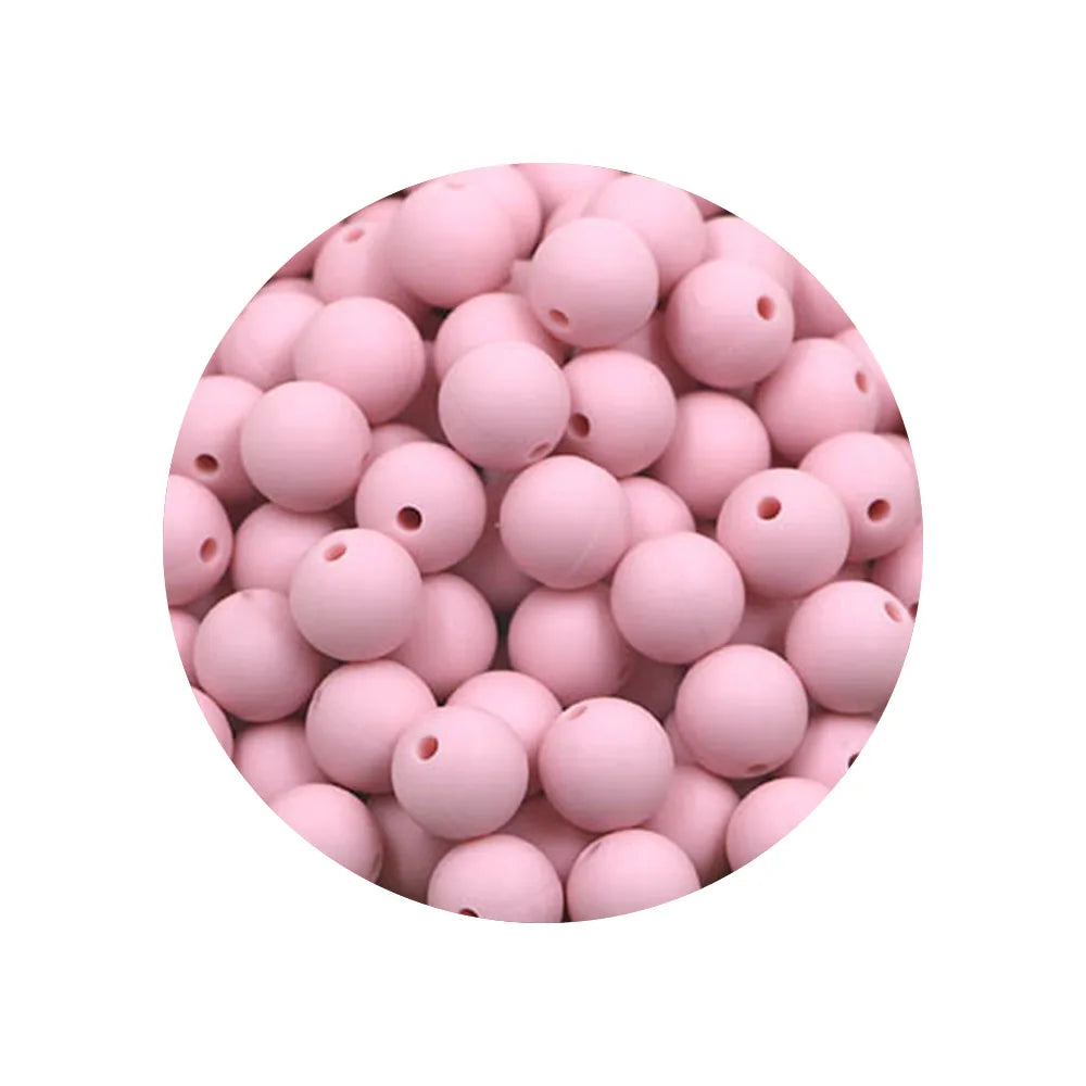 A pile of pink silicone beads in various sizes for DIY jewelry making