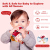 A baby is exploring a soft plush farm animal set with sound and sensory play features.