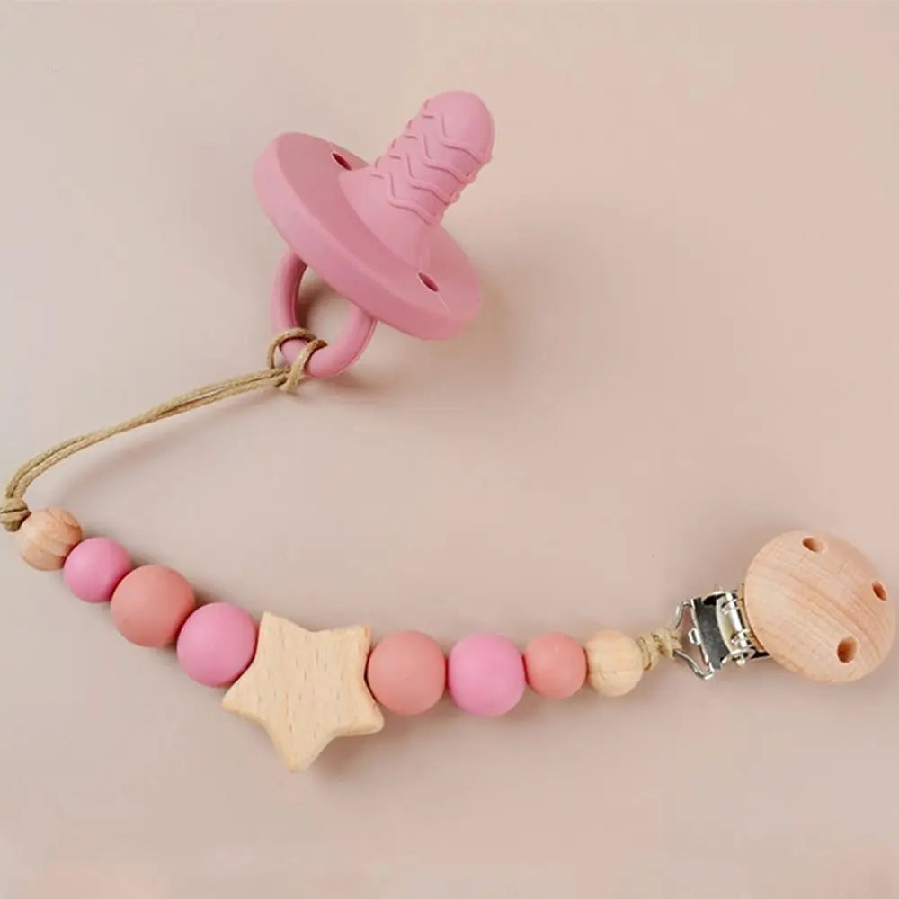 Pink silicone pacifier clip with a wooden bead necklace for a baby