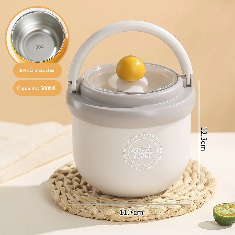 A white insulated stainless steel breakfast cup with a lid is shown resting on a woven mat.