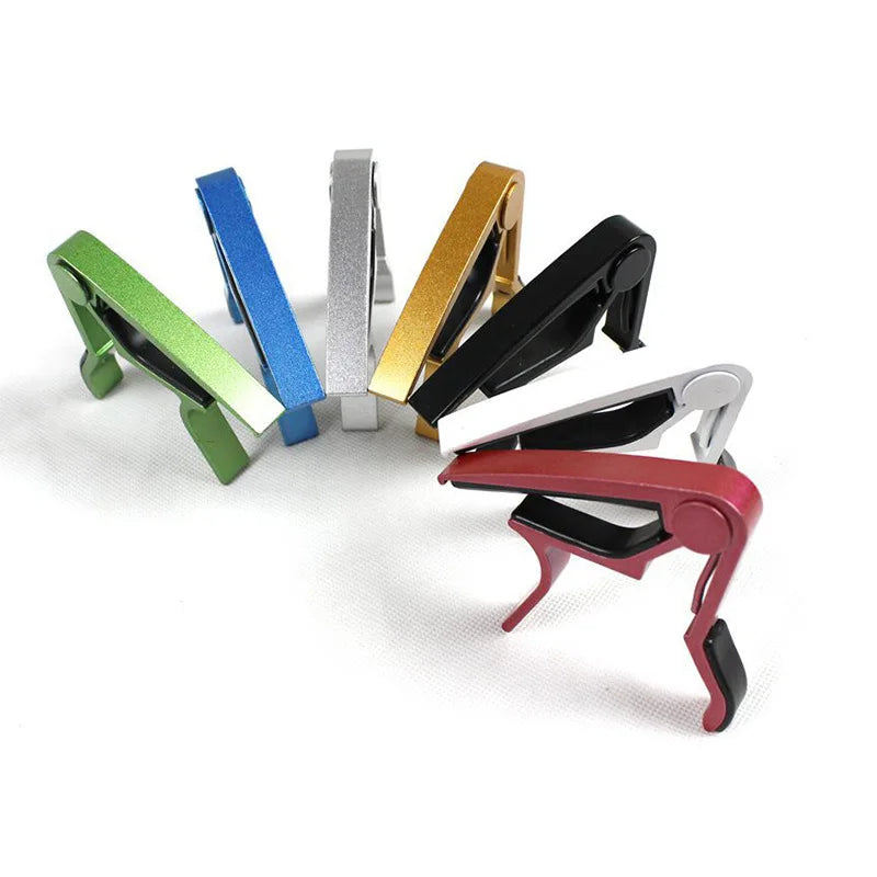 A collection of colorful aluminium alloy quick-release guitar caps visible in various angles.