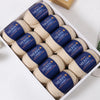 A box filled with dark blue yarn balls labeled YEDAN MERIN Worsted wool thread for knitting projects.