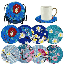 A collection of eight floral resin diamond painting coasters with a holder.