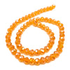 A strand of small, faceted orange crystal beads for jewelry making