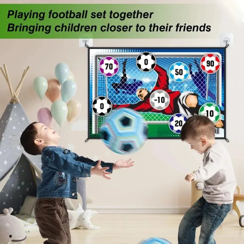 A child is playing football with a soccer game mat set and sticky ball indoors.