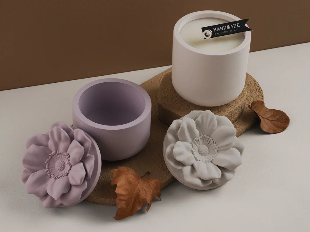A set of handmade floral silicone molds in lavender and light gray are displayed on a white surface.
