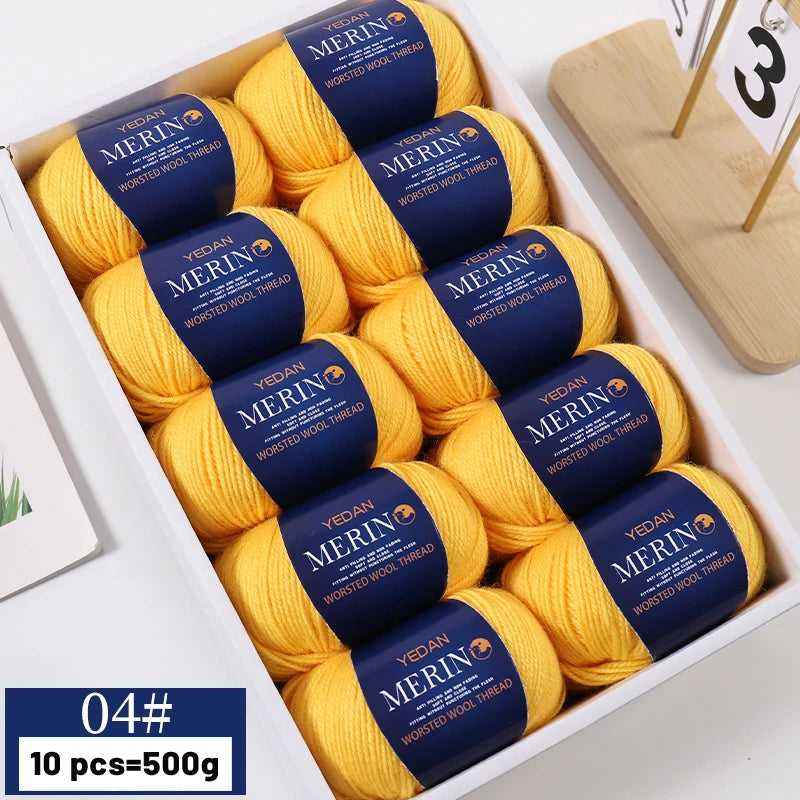 A box containing ten balls of yellow merino wool yarn with blue labels for knitting projects