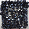 A collection of faceted black glass bicone beads for jewelry making.