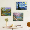 A collection of three oil paintings depicting landscapes and seascapes, displayed on a white wall above a table.