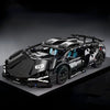 A black 1:14 scale RC sports car building kit with a spoiler and blue accents displayed on a dark surface.