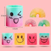 A set of 12 rainbow stacking circles play set featuring various colors and designs like faces and sunburst patterns.