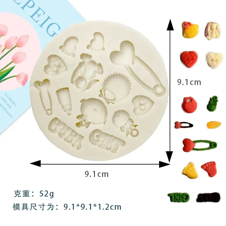 A set of silicone baby-themed cake molds including shapes for strollers, bottles, pacifiers, and other items.