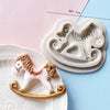 A set of white silicone cake molds featuring a horse design, including a larger mold and a smaller decorative piece.