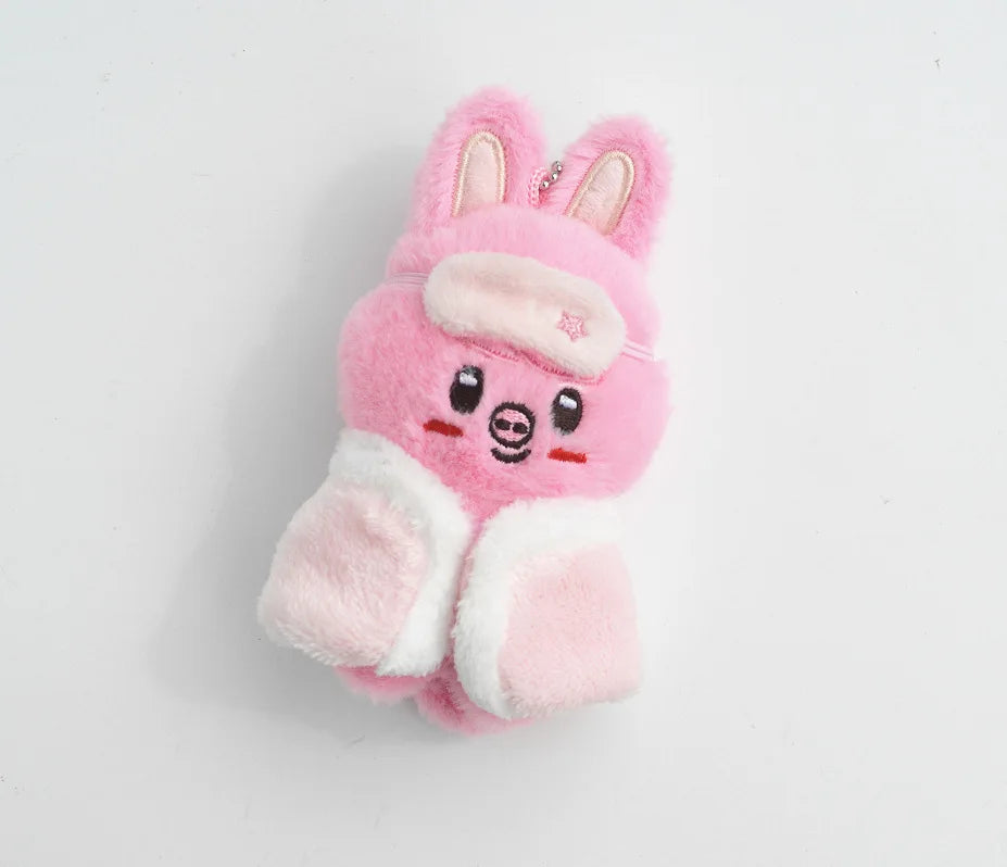A pink and white fluffy cartoon rabbit plush keychain with pink ears and a light pink face.