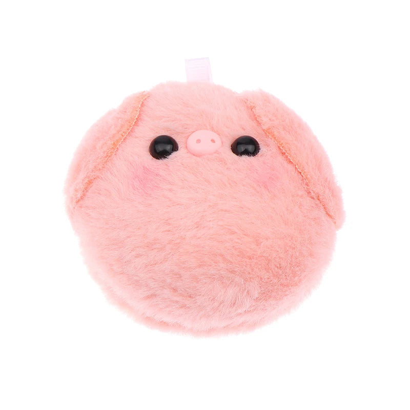 A pink plush pig keychain with black eyes and a white tag.