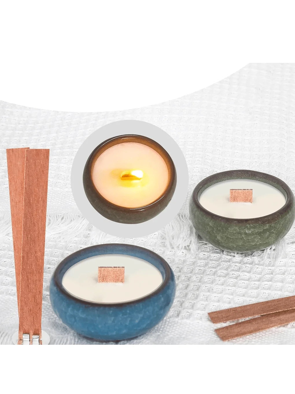 A set of cherry wood candle wicks with iron brackets and glue dots displayed on a white textile background.