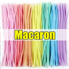 A bundle of multicolor chenille stem pipe cleaners in various pastel colors.