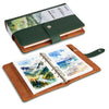 A green and brown watercolor sketchbook with lay-flat binding and a leather cover.