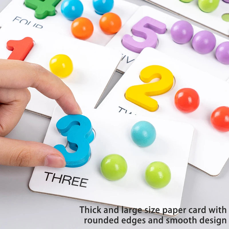 A hand is placing a blue wooden clip bead onto the number three card of a Montessori toy set.