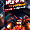A red inertia-powered spider crawling toy car is held in a person's hand against a dark background.