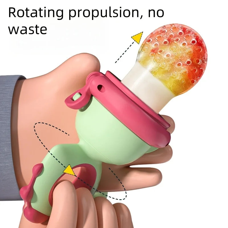 A hand holds a pink and green dinosaur-shaped rotating fruit feeder with a textured orange top.