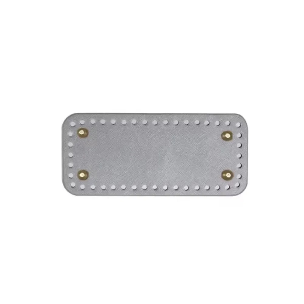 A rectangle shaped PU leather crochet bag bottom with pre-punched holes.