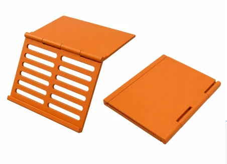 Orange foldable mahjong card holder with a non-slip stand and slotted design