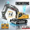 A yellow engineering vehicle excavator with a remote control transmitter and interchangeable parts is shown.