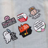 A collection of embroidered patches featuring quotes about mental health, self-worth, and resilience on a light denim fabric.
