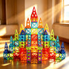 A colorful tower built from magnetic building tiles in various geometric shapes and colors.