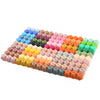 A colorful array of hexagonal silicone beads in various shades of pink, purple, blue, green, and orange arranged in a grid.