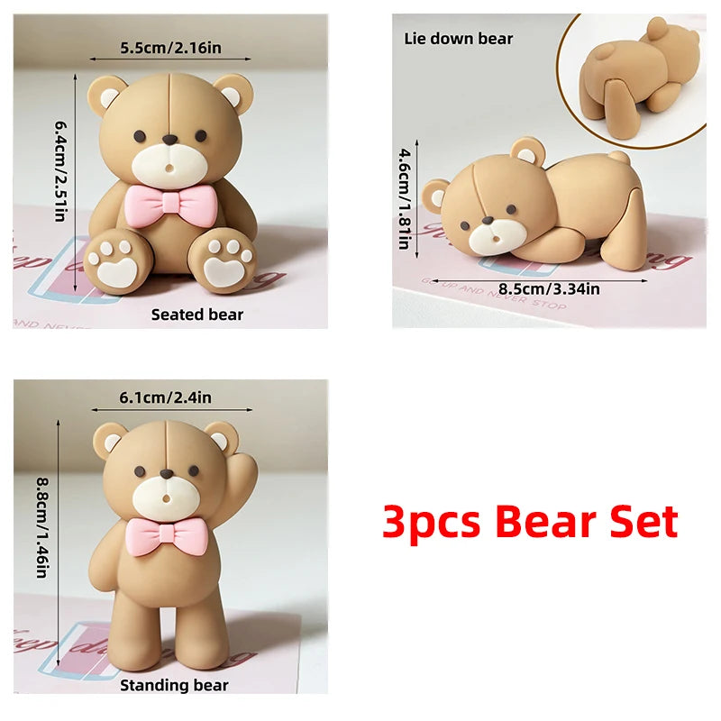A set of three adorable bear figures in a light tan color, including seated, lying down, and standing poses.