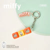 A Miffy keycap pendant keychain featuring three different character designs on an orange background.