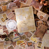 A collection of vintage paper and stickers used for crafting, featuring handwritten letters and aged textures.