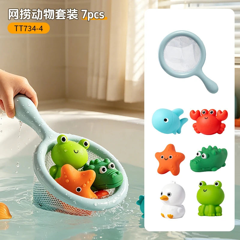 A hand is holding a silicone bath toy set of 7 plastic turtles and an orange starfish in water, with a fishing net visible.