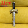 A silver dagger with a gold hilt and black grip is displayed on a yellow fabric background.