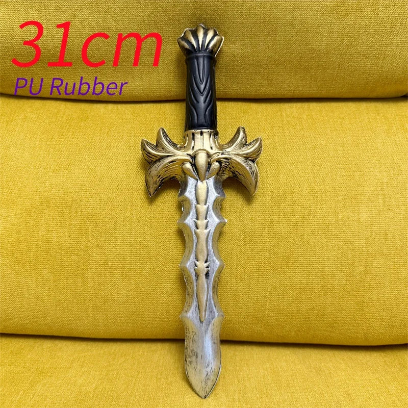 A silver dagger with a gold hilt and black grip is displayed on a yellow fabric background.