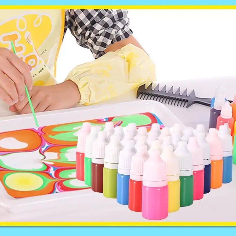 A set of water marbling paint art kits with various colored bottles and a plastic palette are shown on a white tray.