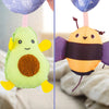 Two colorful felt sensory rattles shaped like an avocado and a bee hanging by strings.