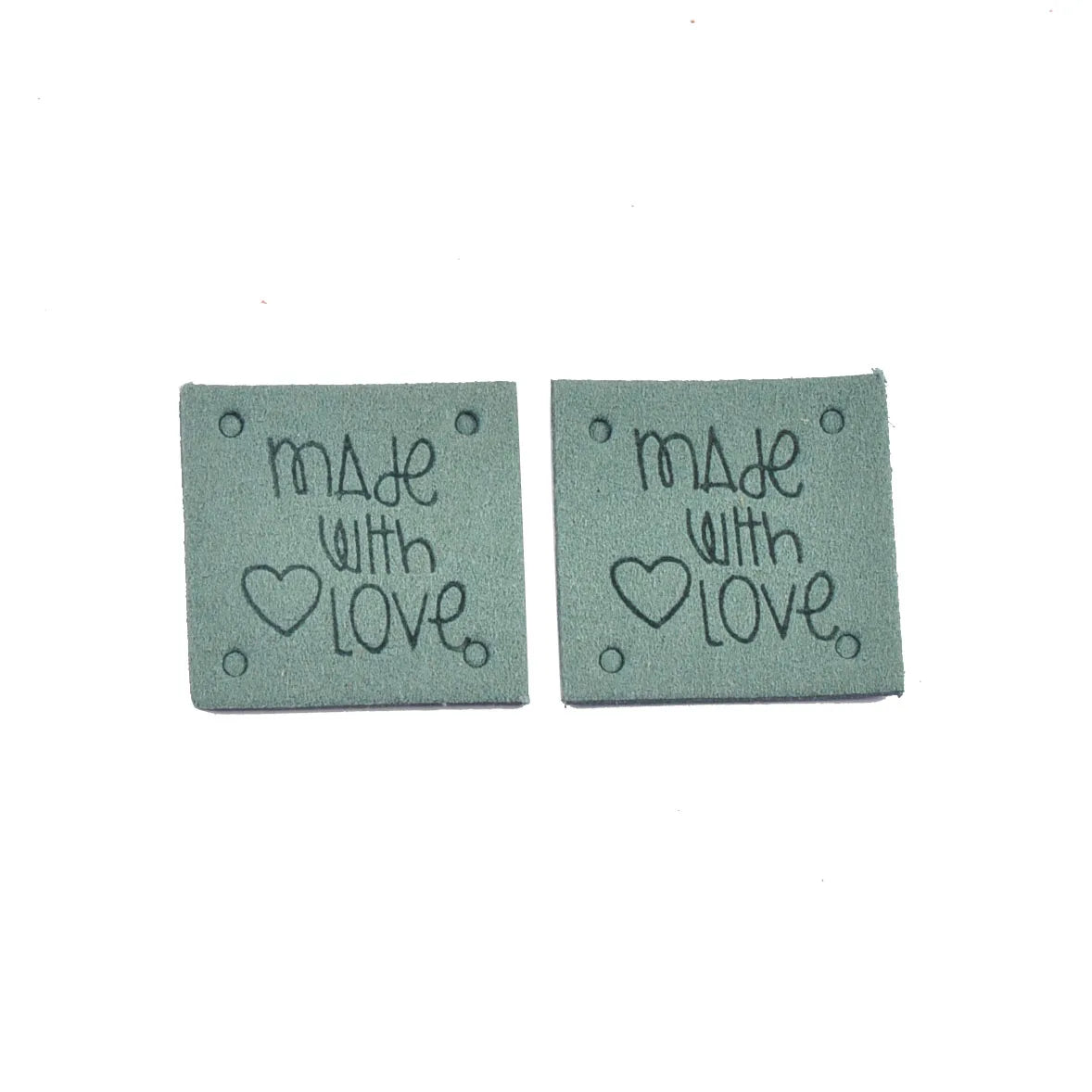 Two gray embossed leather labels with the text Made with Love and a heart symbol.