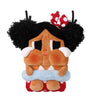 A plush figure of a crying girl with black curly hair and a red bow, wearing a blue bandage.