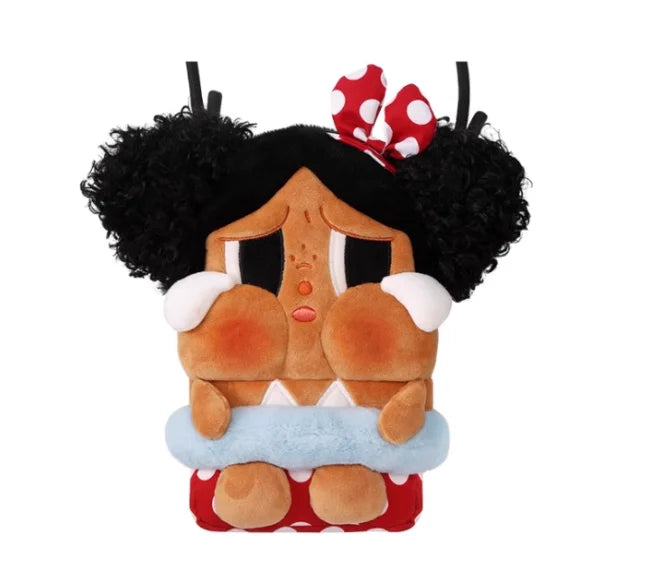 A plush figure of a crying girl with black curly hair and a red bow, wearing a blue bandage.