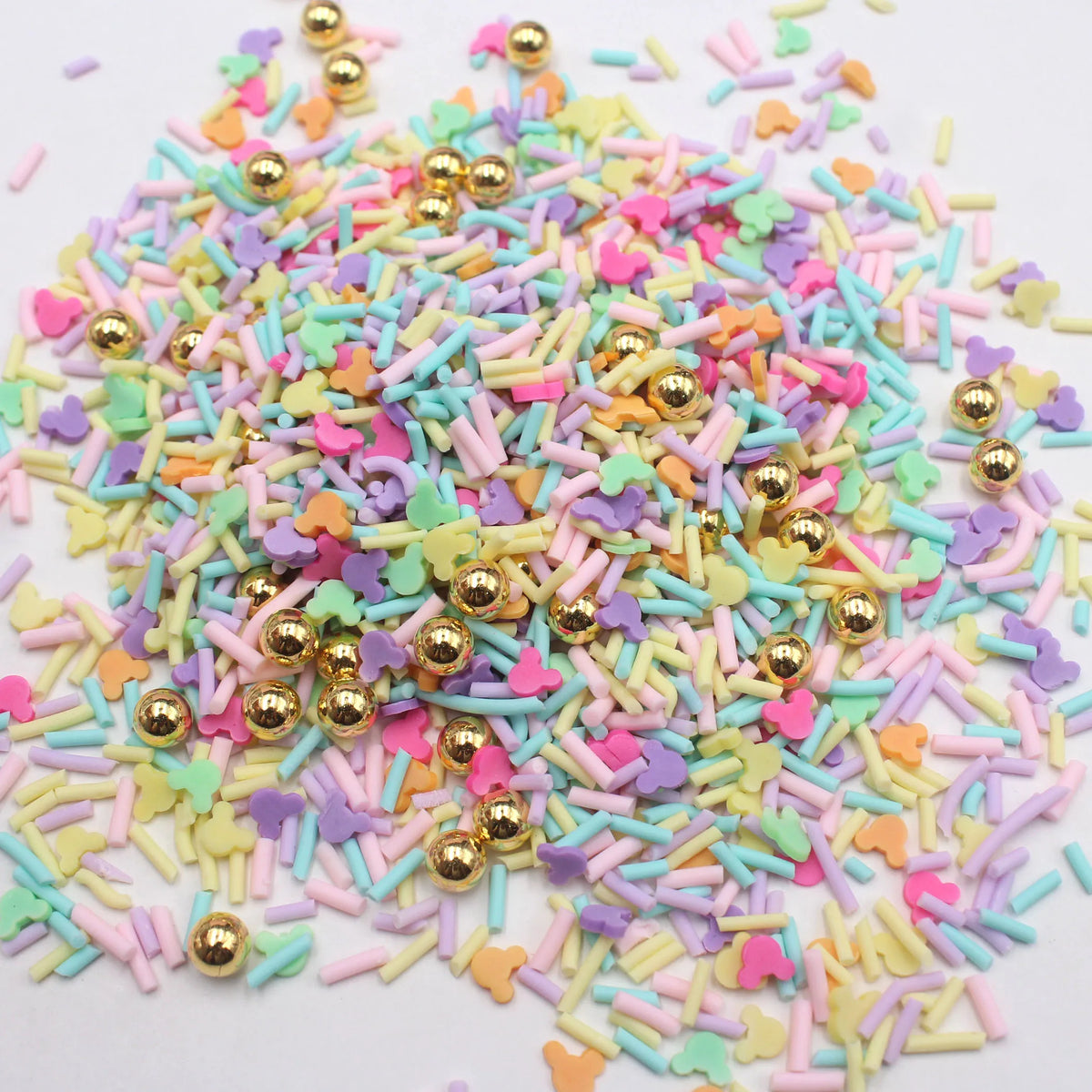 A pile of colorful polymer clay slices in various pastel shades including pink, purple, green, and yellow.