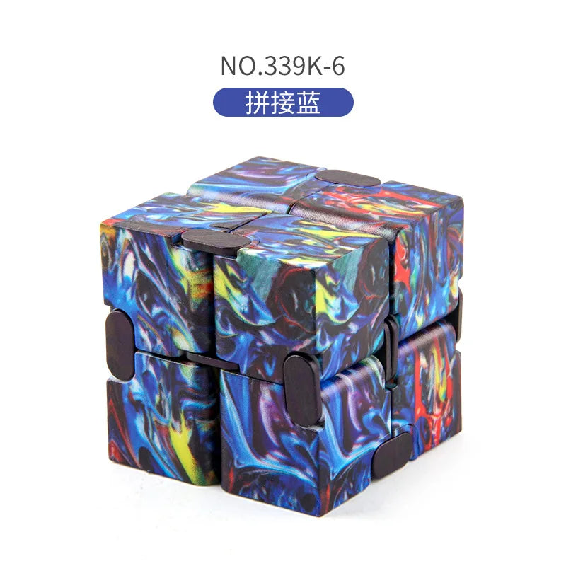 A colorful fidget cube with a marbled, cosmic design, shown from above.